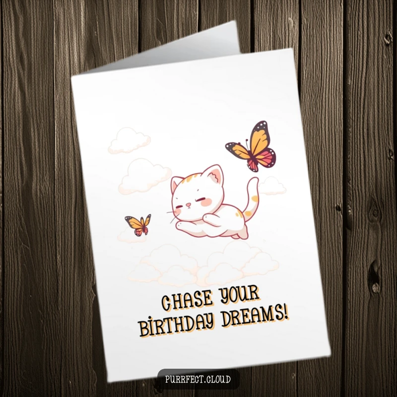 Funny Free Printable Birthday Card showing a cute cat playfully chasing a butterfly among fluffy clouds.