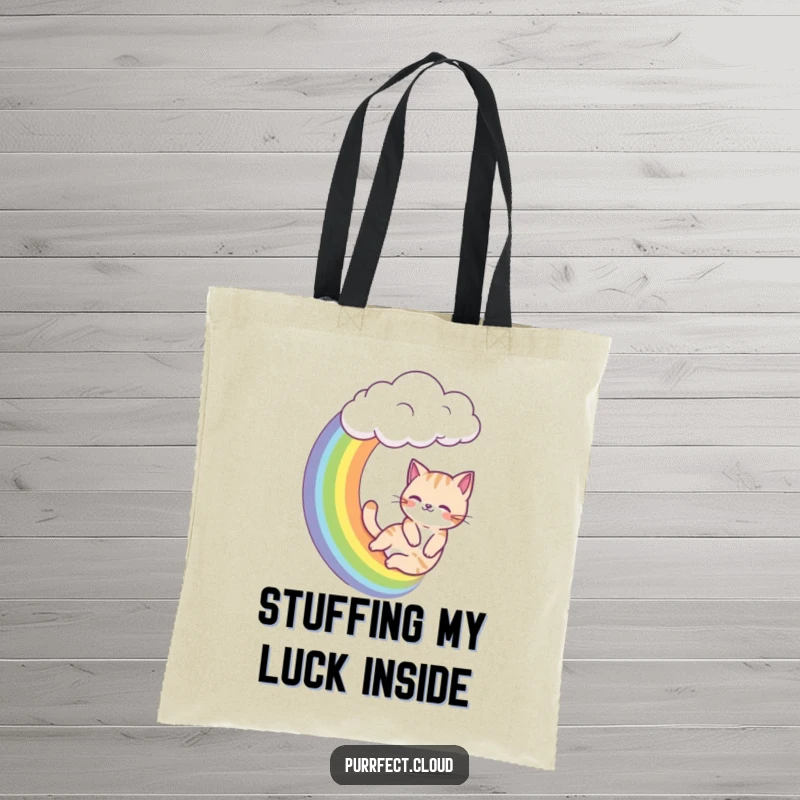 Funny cat tote bag, a cat slides down a rainbow from a cloud, cheerful and practical accessory.